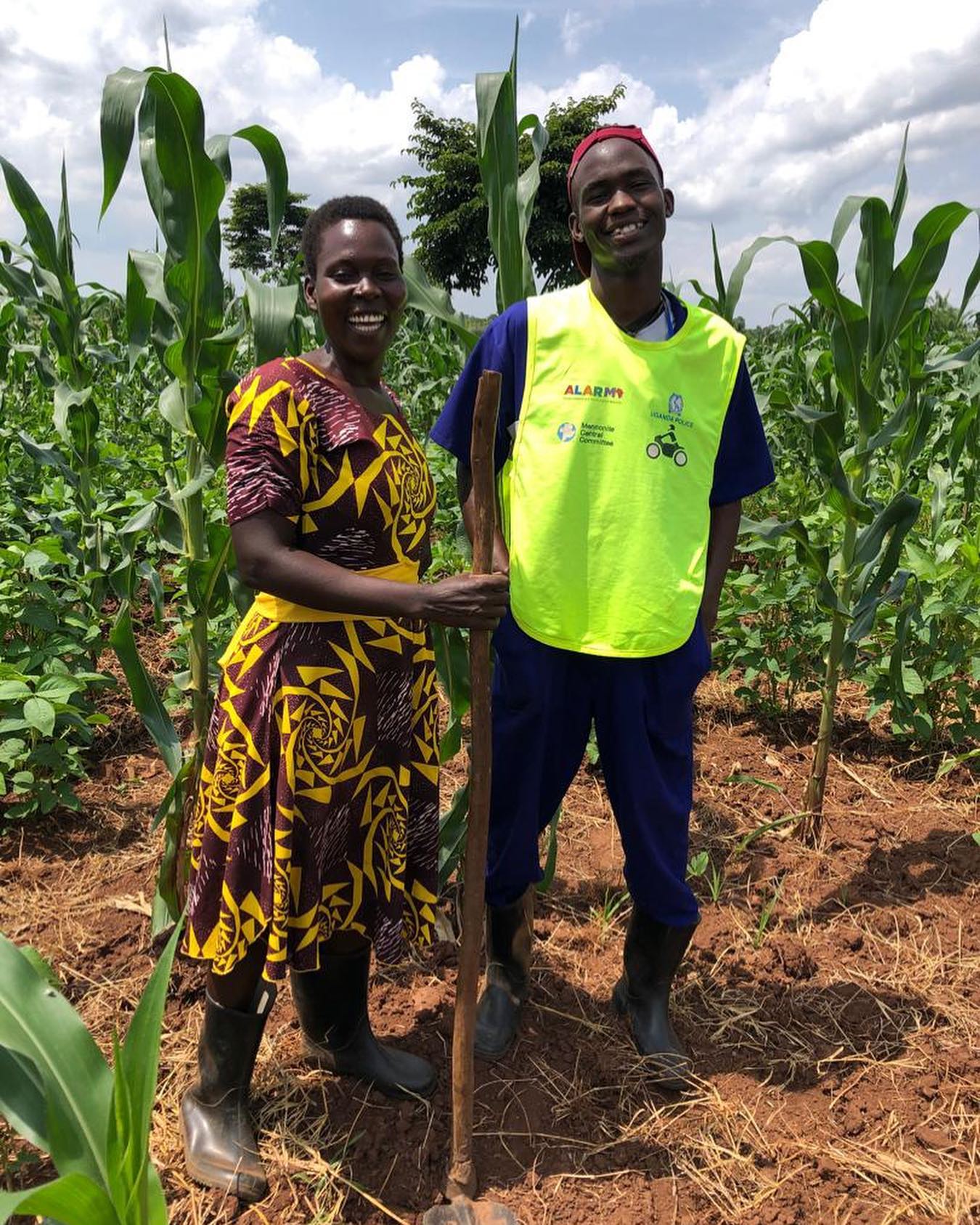 A roadside sign reading 'God's Grace Spare Parts — Supported by SEW', standing on a dusty street in Lira — one of the businesses launched through the programme